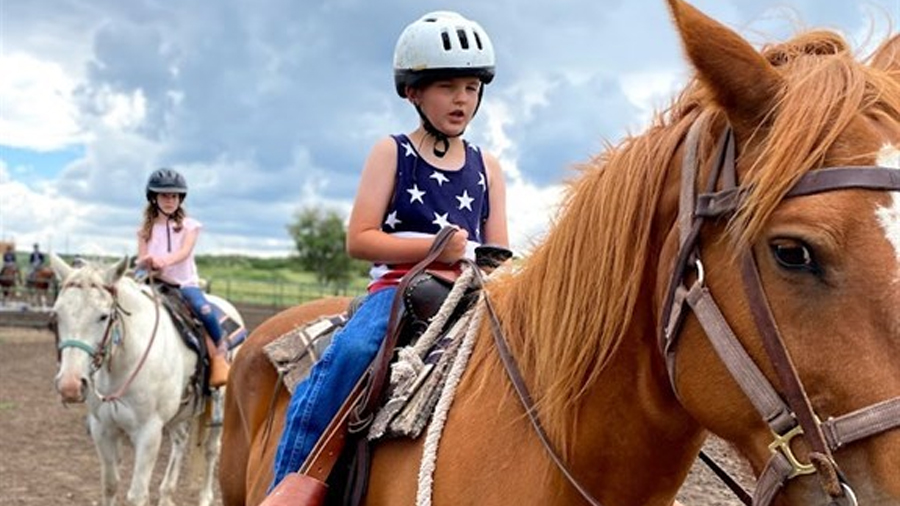 Two young kids on horses